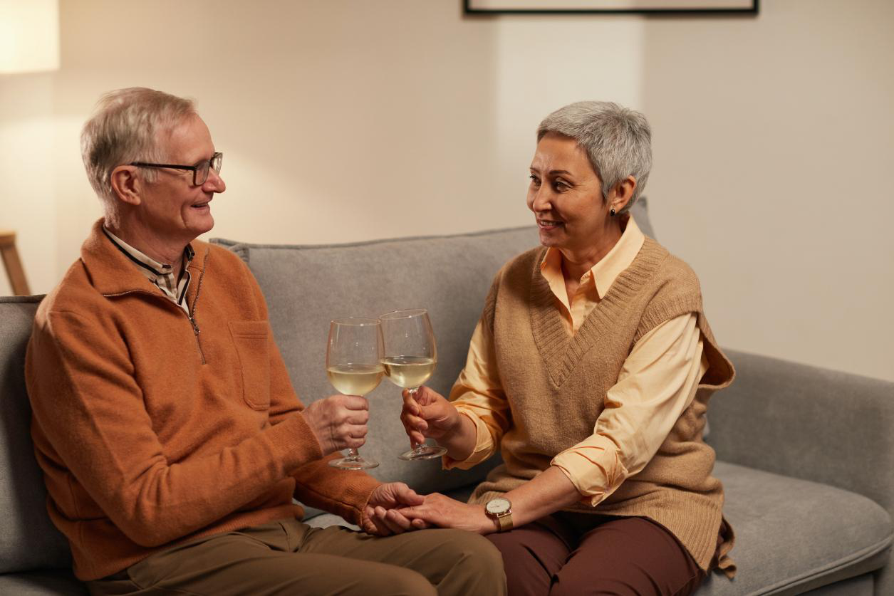 A senior couple enjoying wine at a senior living community in California