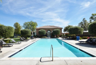 An image of a big outdoor pool at Orchid at Pacific Mayfield in Menifee, CA.